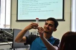 Volunteers and students working together during a workshop