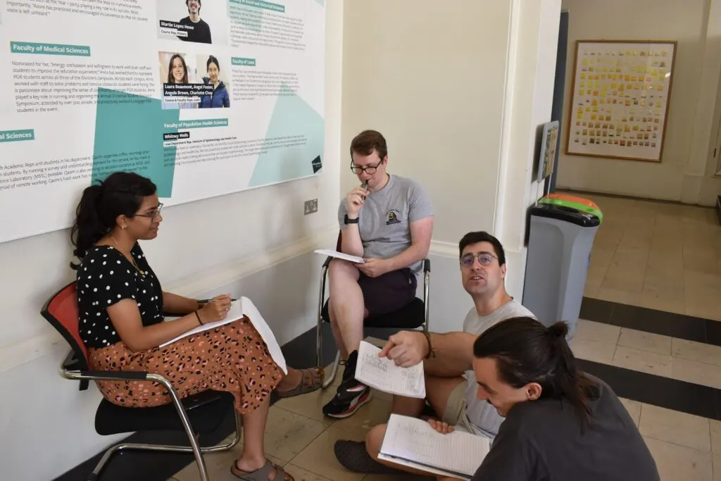 A volunteer mentor supporting a student in a laboratory workshop